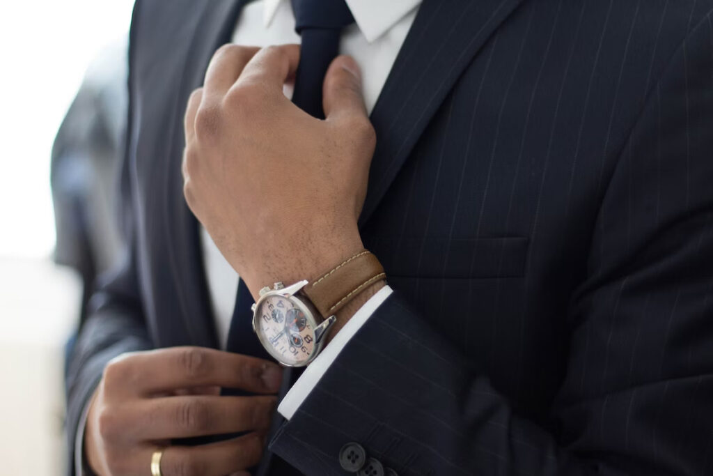 a man in his professional and sleek suit and tie paired with a nice watch