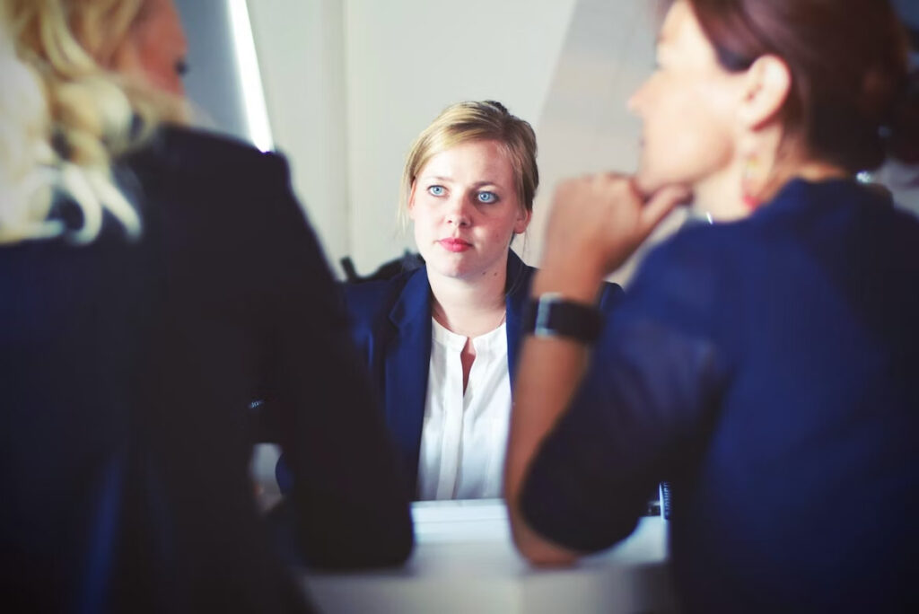 a woman with beautiful eyes listening to her co-workers