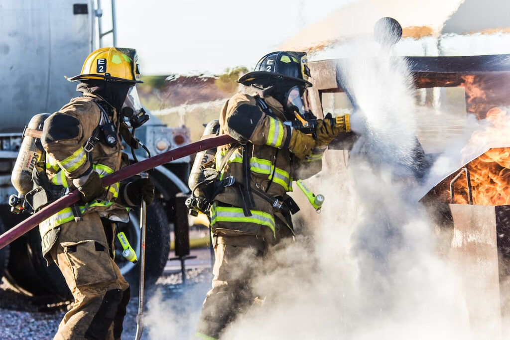 a group of policemen in their work suit, putting out fire