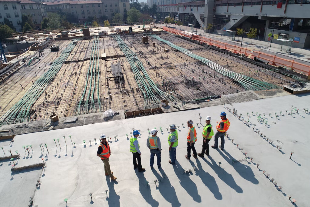 a group of engineers at a construction area, inspecting and managing a project