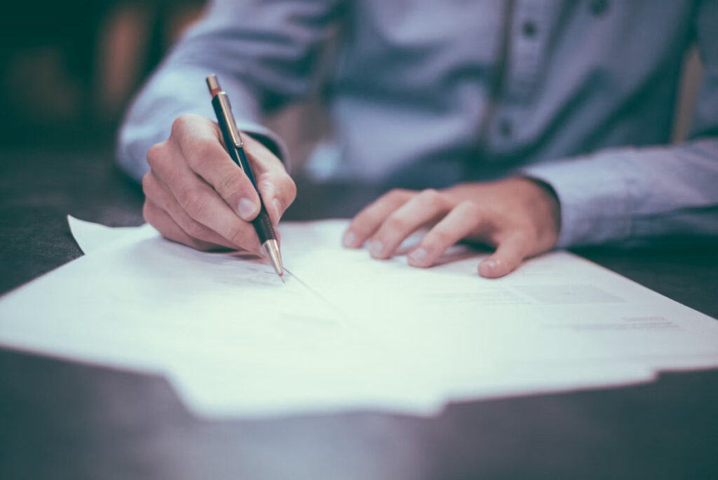 a man signing some documents