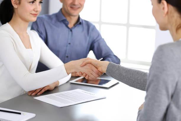 two women shaking hands