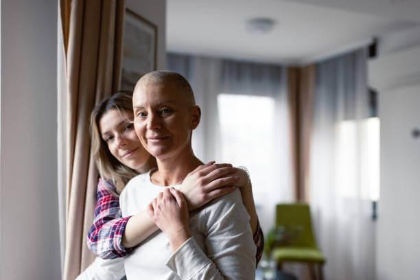a woman hugging the woman in white