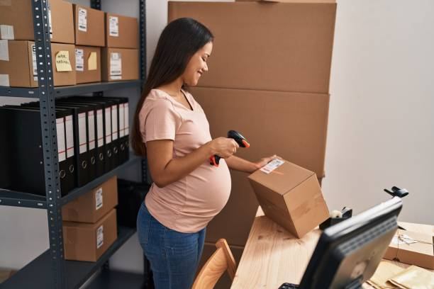 a pregnant woman scanning a package