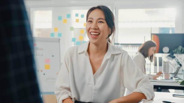 a woman in white shirt laughing in a room