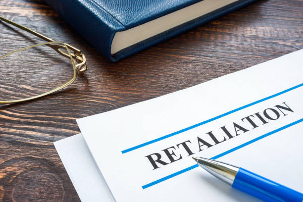 photo of a paper with a pen and the word retaliation on it