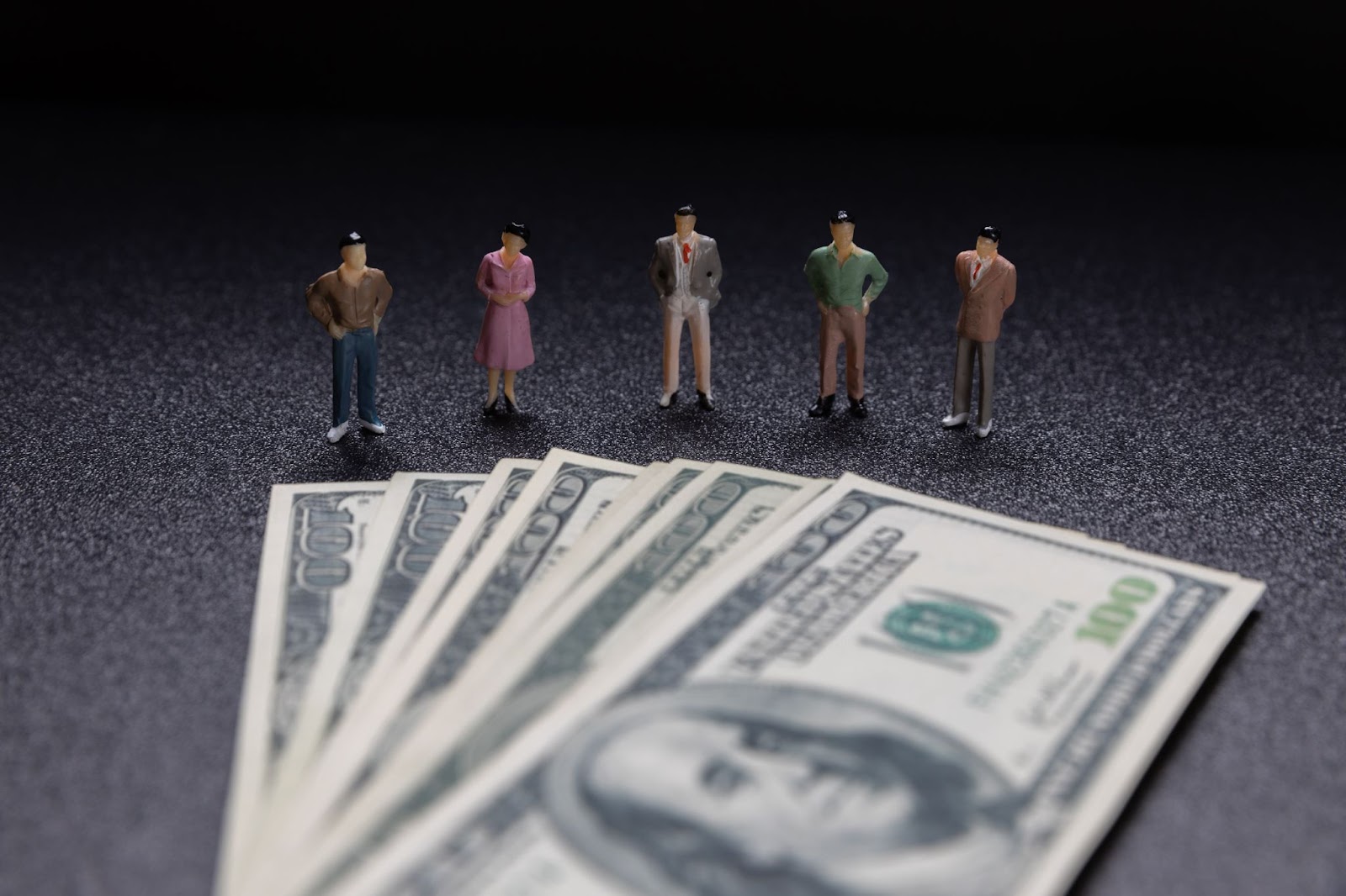 image showing a group of professionals in front of some bills